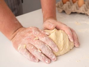 chef-molding-dough-with-eggs