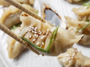close-up-sticks-holding-asian-food
