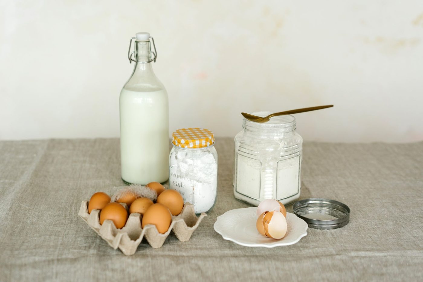 A mixing bowl with gluten free flour and dairy free milk being stirred into cornbread batter on a kitchen counter.